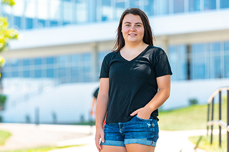 Photo of Natalie West in front of Iowa Hall